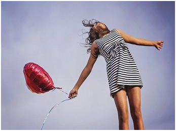 Healthy girl holding a balloon