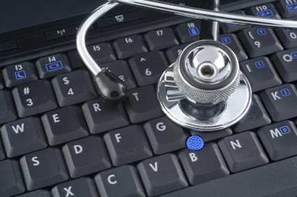 stethoscope lying on keyboard of a laptop