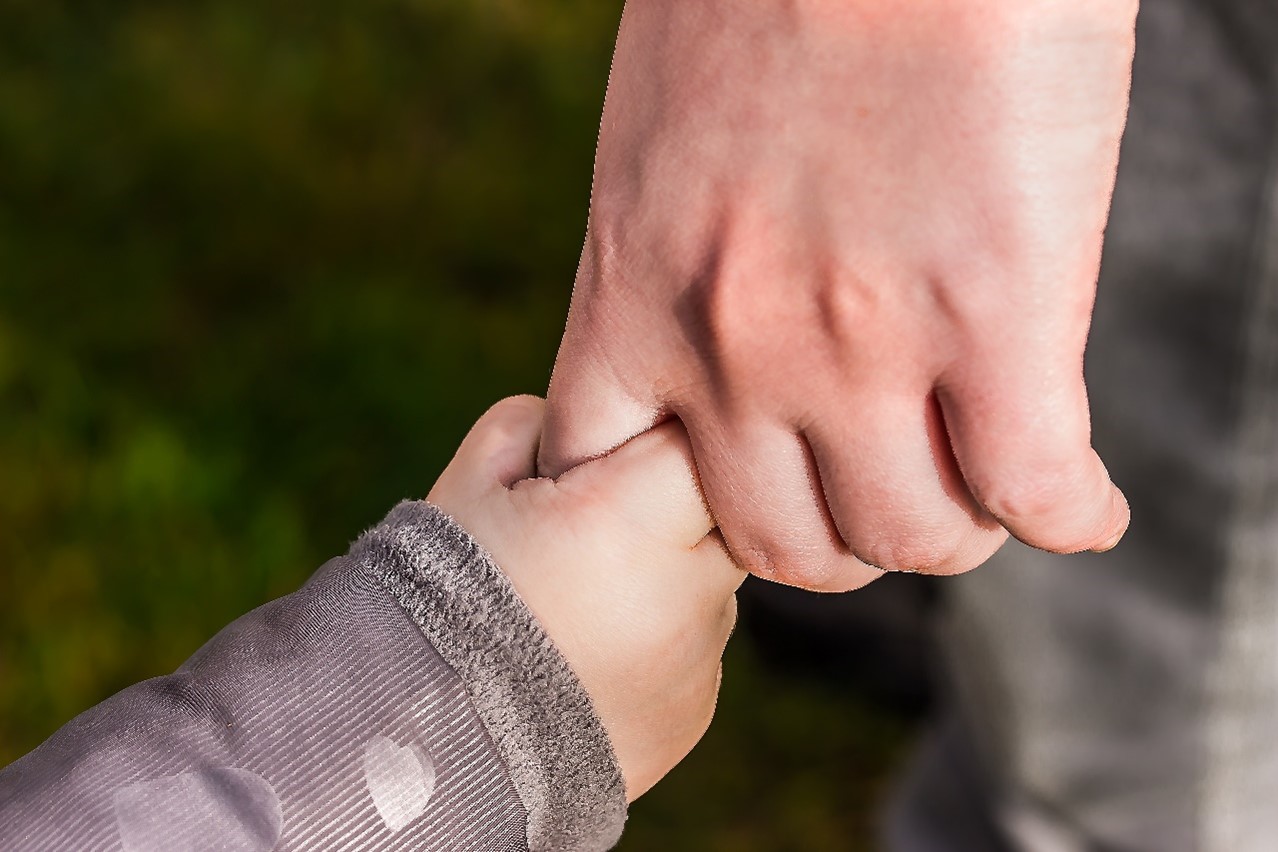 Child Holding Hand of Another Person