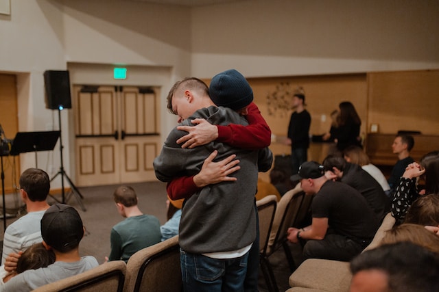 Two people hugging during a support group